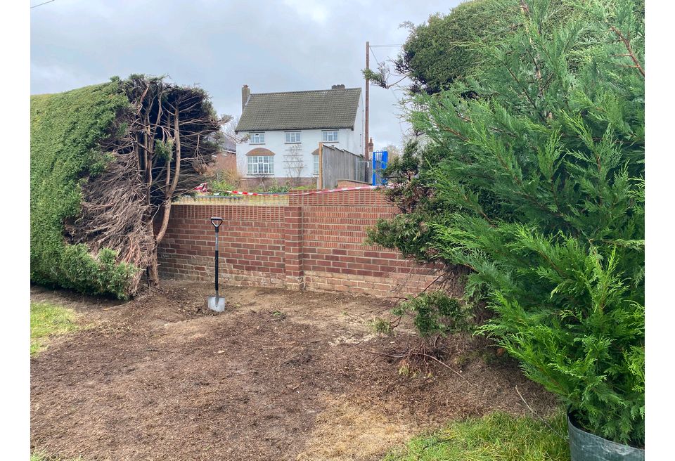 Plants were cleared and after the wall was rebuilt the ground was prepared for replanting